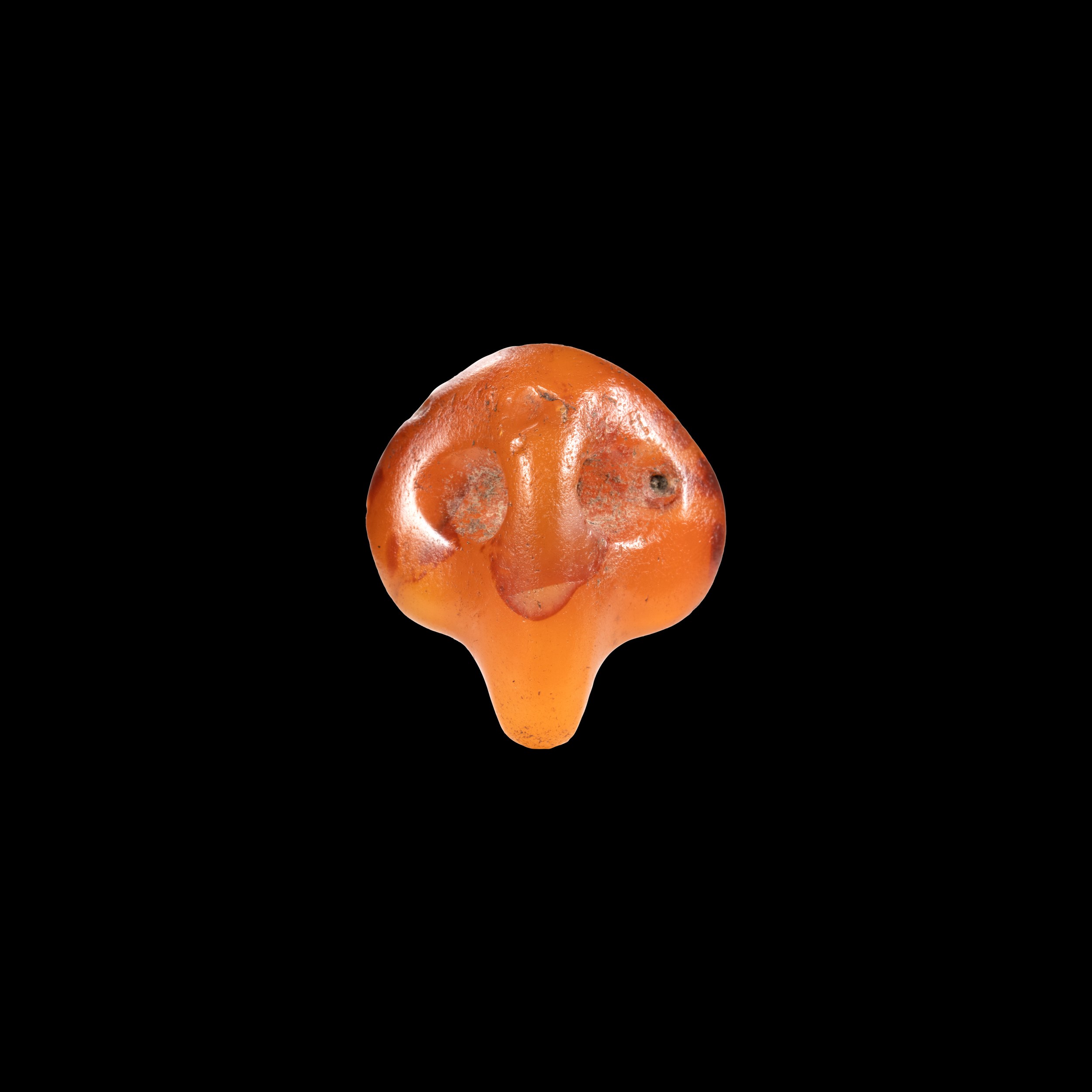 A rare Predynastic carnelian 'Bull's head' pendant amulet. 
